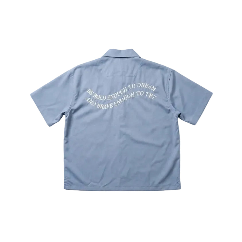 Light blue shirt with text on the back against a white background