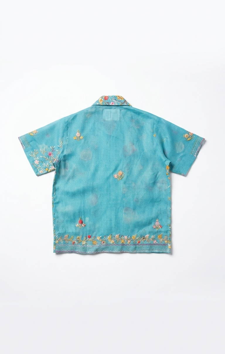Blue embroidered shirt on a white background