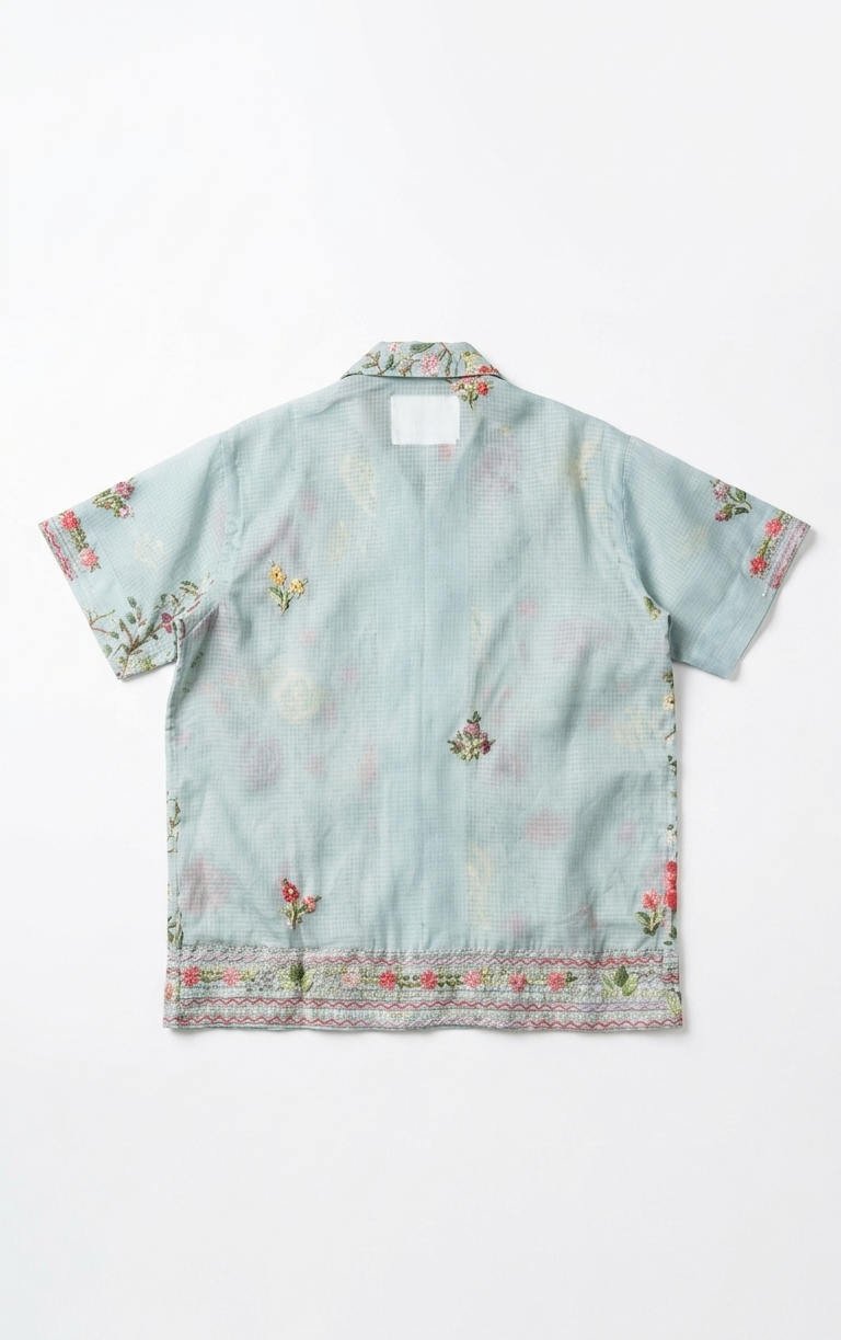 Light blue shirt with floral patterns on a white background