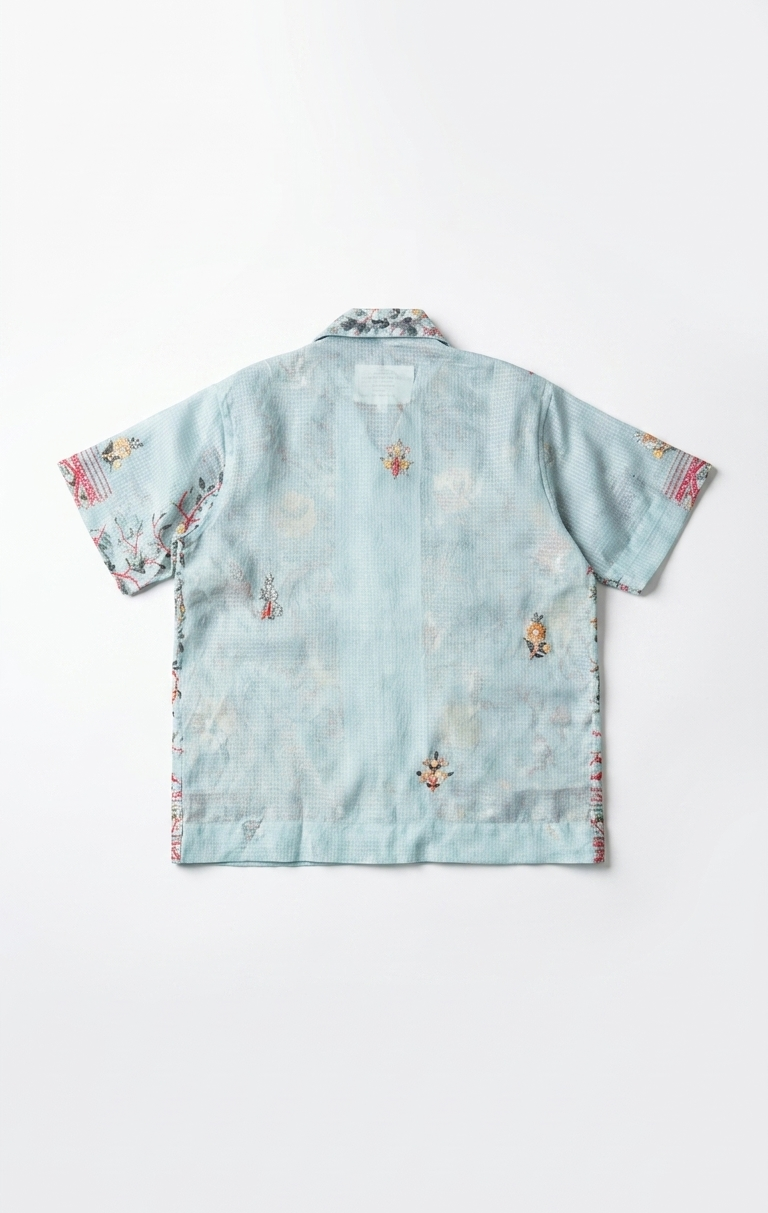 Light blue shirt with floral patterns on a white background