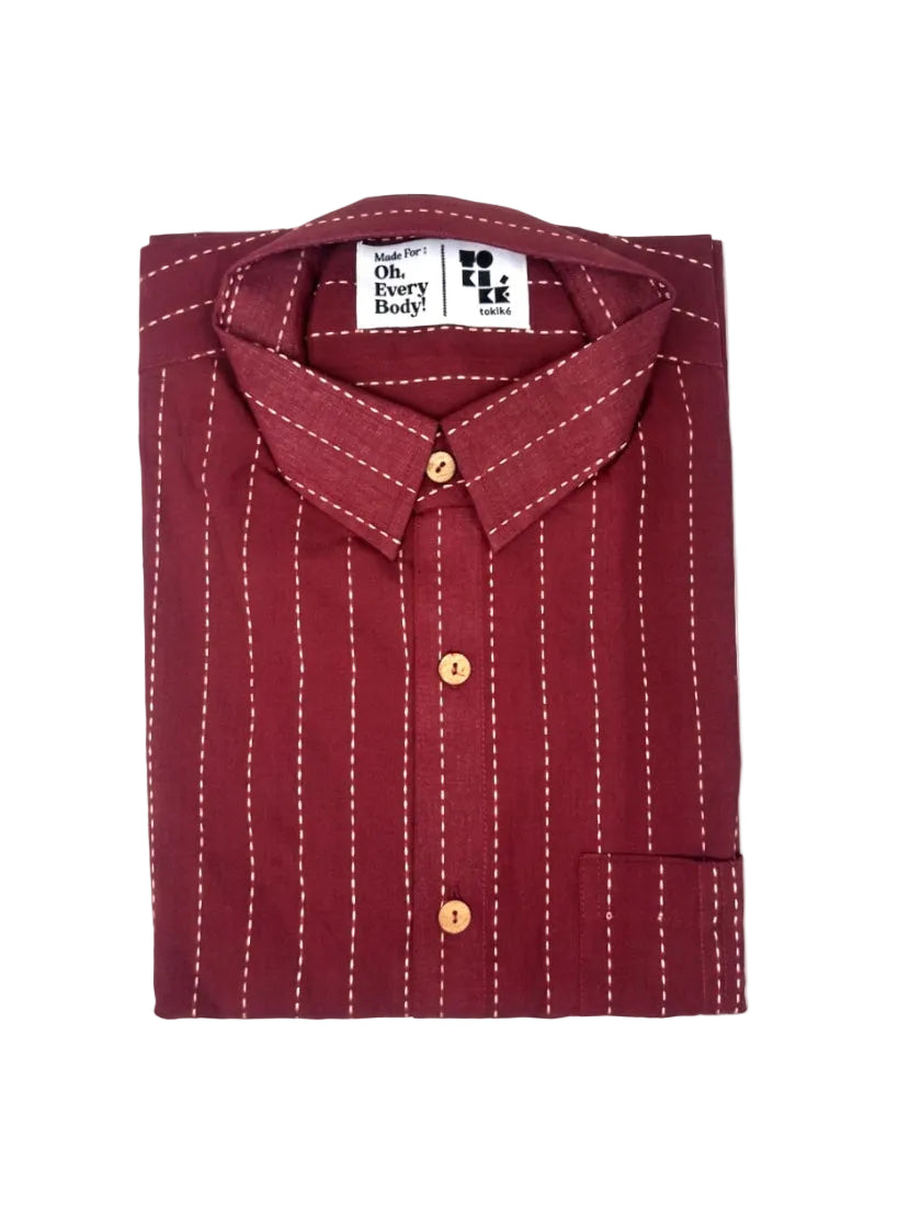 A folded maroon long-sleeve button-down shirt with white vertical pinstripes and white contrast stitching, featuring a white neck label that reads 'Made for Oh. Every Body! by KKK Garments'.