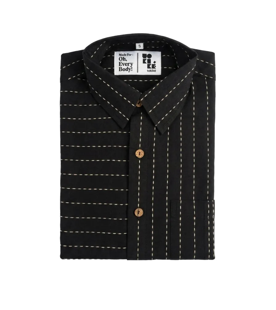 A folded black long-sleeve button-up shirt with white dashed vertical pinstripes and brown buttons, displayed on a clean white background. The inner collar label shows the brand 'Made For Oh, Every Body!'.