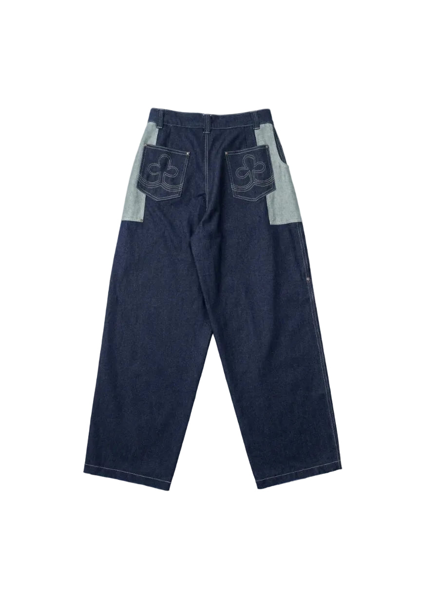A pair of dark blue denim pants shown from the back, featuring light blue contrast panels on the upper back pockets and side seams, with white contrast stitching throughout.
