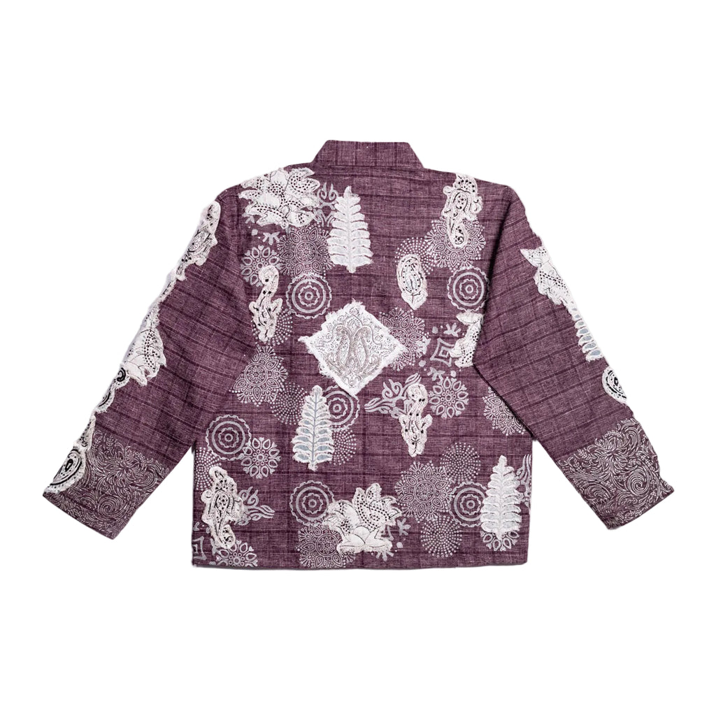 A long-sleeve button-up shirt shown from the back, featuring a dark plum purple base with a white hand-drawn style pattern of trees, circles, and abstract motifs.
