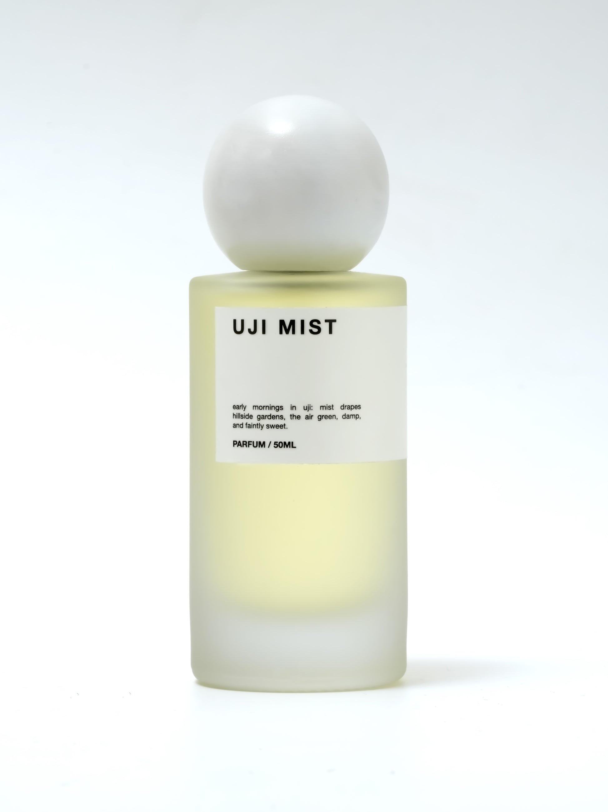 Perfume bottle labeled 'UJI MIST' on a white background